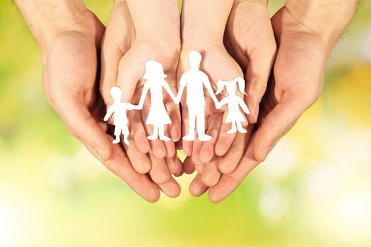 paper family in hands on bright background photo